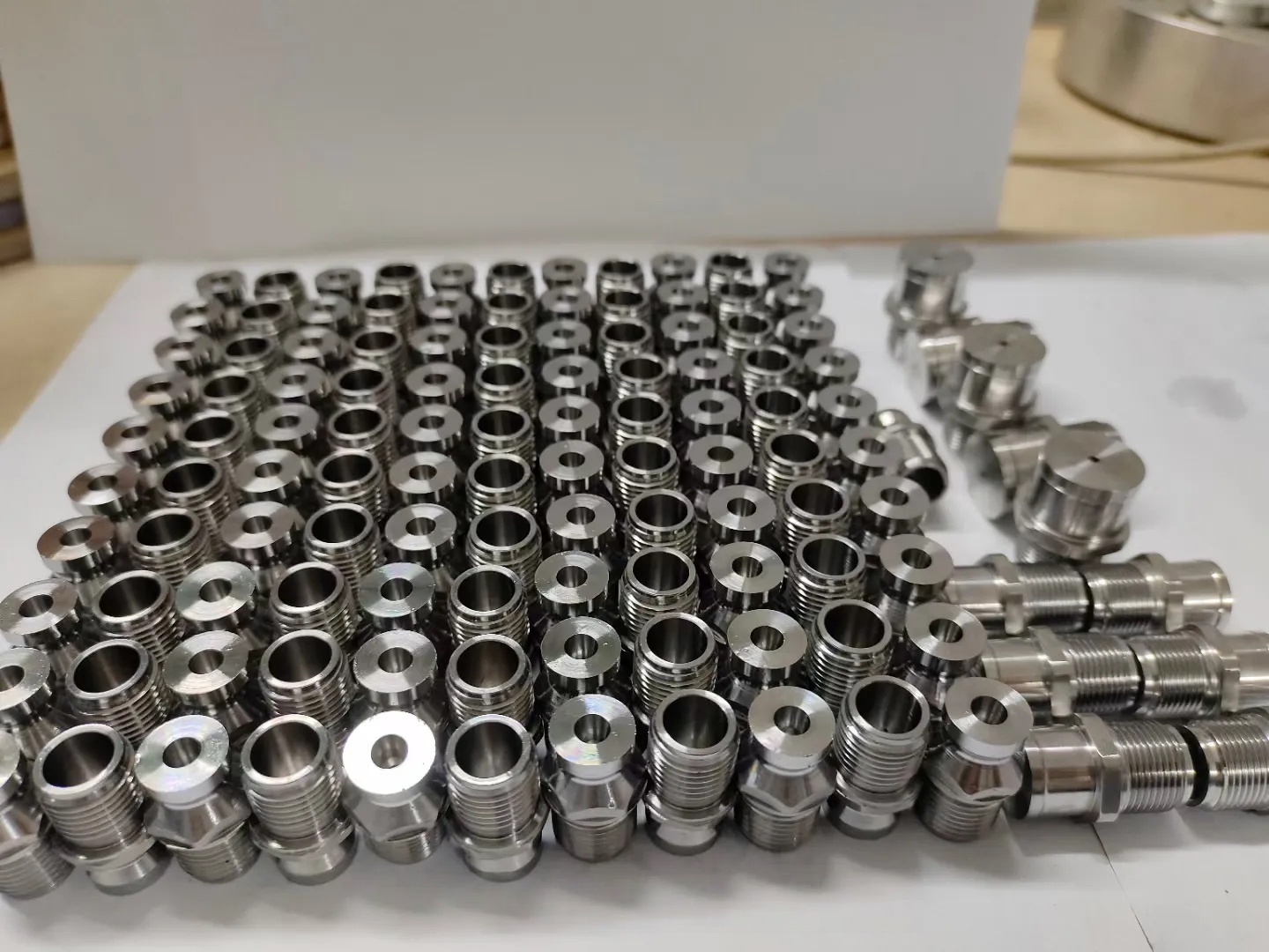 Custom threaded nozzles and compact fittings